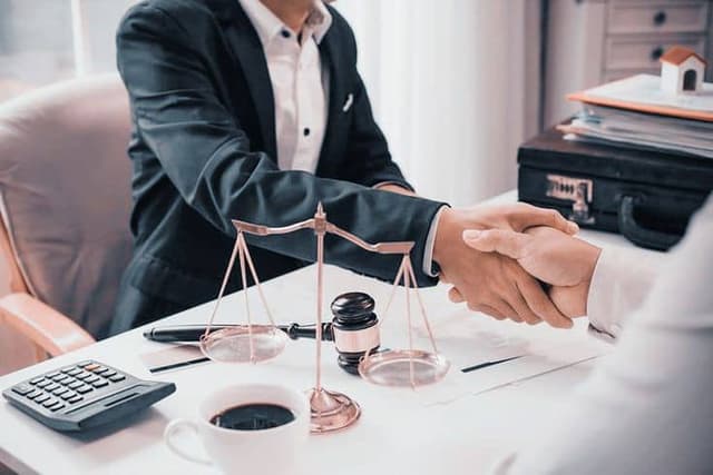Image of people shaking hands in office